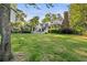 Expansive backyard featuring a lush lawn, mature trees, charming gazebo, and an inviting outdoor seating area at 4770 Hilltop Nw Dr, Acworth, GA 30101