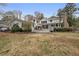 Expansive backyard view showcasing the home's exterior, deck, and green lawn at 4770 Hilltop Nw Dr, Acworth, GA 30101