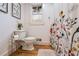 Cozy bathroom with wooden floors, a floral shower curtain, a window and neutral colors at 4770 Hilltop Nw Dr, Acworth, GA 30101