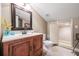 Cozy bathroom featuring a wood vanity, sink, toilet, and built-in storage nook at 4770 Hilltop Nw Dr, Acworth, GA 30101