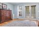 Bedroom featuring hardwood floors, neutral walls, and French door access to the outside at 4770 Hilltop Nw Dr, Acworth, GA 30101