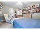 Comfortable bedroom with carpet, a vintage wooden bed frame, a ceiling fan, and decorative shelves at 4770 Hilltop Nw Dr, Acworth, GA 30101