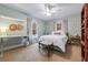 Charming bedroom with neutral walls, a ceiling fan, carpeted floor, and natural light from windows at 4770 Hilltop Nw Dr, Acworth, GA 30101