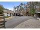 Long driveway leading to house with multiple vehicles parked under carports at 4770 Hilltop Nw Dr, Acworth, GA 30101