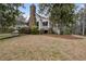 Exterior view of home with brick chimney, covered porch, and natural landscaping at 4770 Hilltop Nw Dr, Acworth, GA 30101