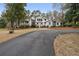 Charming home featuring a circular driveway and a manicured front yard with mature trees at 4770 Hilltop Nw Dr, Acworth, GA 30101