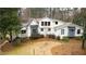 Stunning modern farmhouse with white siding, gray accents, and a professionally landscaped yard at 4770 Hilltop Nw Dr, Acworth, GA 30101