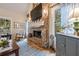 Close-up of brick fireplace with mantel, hearth, and decor in a sunlit room at 4770 Hilltop Nw Dr, Acworth, GA 30101