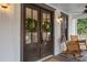 Inviting front door with wreaths, rocking chairs, and a welcoming porch setting at 4770 Hilltop Nw Dr, Acworth, GA 30101