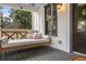 Cozy front porch with a cushioned porch swing and a view of the surrounding landscape at 4770 Hilltop Nw Dr, Acworth, GA 30101