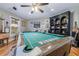 This game room includes a pool table, wooden floors, and eclectic decor at 4770 Hilltop Nw Dr, Acworth, GA 30101