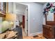 Hallway view featuring a lamp, wooden floors, blue walls, and a decorative vintage cabinet at 4770 Hilltop Nw Dr, Acworth, GA 30101