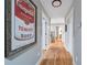 Bright hallway featuring artwork, wood floors, neutral walls, and white trim at 4770 Hilltop Nw Dr, Acworth, GA 30101