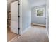 Upstairs hallway featuring neutral paint, carpet, doors, and trim at 4770 Hilltop Nw Dr, Acworth, GA 30101