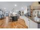 Spacious kitchen features granite countertops, white cabinets, stainless steel appliances, and hardwood floors at 4770 Hilltop Nw Dr, Acworth, GA 30101