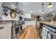Gourmet kitchen with stainless steel stove, custom range hood, and open design into living spaces at 4770 Hilltop Nw Dr, Acworth, GA 30101