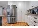 Kitchen with stainless steel refrigerator, white cabinets, and adjacent countertop appliances at 4770 Hilltop Nw Dr, Acworth, GA 30101