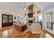 Warm and inviting living room featuring a brick fireplace, hardwood floors, and stylish furnishings at 4770 Hilltop Nw Dr, Acworth, GA 30101