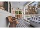 Charming screened-in porch with rustic furniture and a view of the wooded backyard at 4770 Hilltop Nw Dr, Acworth, GA 30101