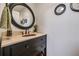 Elegant powder room boasts a granite countertop, black vanity, and oil rubbed bronze faucet at 4770 Hilltop Nw Dr, Acworth, GA 30101