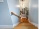 Downstairs staircase featuring hardwood steps, neutral walls, and decorative wall hangings at 4770 Hilltop Nw Dr, Acworth, GA 30101