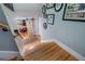 Downstairs staircase featuring hardwood steps and a rustic sliding barn door at the bottom of the stairs at 4770 Hilltop Nw Dr, Acworth, GA 30101