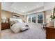 A relaxing main bedroom with a tray ceiling, neutral decor, and large windows for ample natural light at 5837 Schelton Se Pl, Mableton, GA 30126