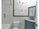 Bathroom featuring a tub, turquoise vanity, white tiled wall, and built in shelf at 2288 Street Deville Ne, Atlanta, GA 30345