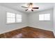 Bedroom features hardwood floors, two windows, neutral paint, and a ceiling fan at 2288 Street Deville Ne, Atlanta, GA 30345