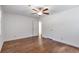 Spacious bedroom featuring hardwood floors, white walls, a ceiling fan, and an entry door at 2288 Street Deville Ne, Atlanta, GA 30345