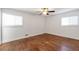 Spacious bedroom featuring hardwood floors, white walls, two windows and a ceiling fan at 2288 Street Deville Ne, Atlanta, GA 30345