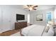 Comfortable bedroom featuring a ceiling fan, hardwood floors, television, a dresser, and neutral decor at 2288 Street Deville Ne, Atlanta, GA 30345