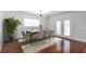 Elegant dining room with hardwood floors, a large dining table, and sliding doors for easy access to outdoor spaces at 2288 Street Deville Ne, Atlanta, GA 30345