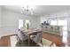 Stylish dining area with a wooden table, seating for eight, and an open view into the kitchen and backyard at 2288 Street Deville Ne, Atlanta, GA 30345