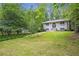 Attractive home featuring an expansive lawn, mature trees, and a welcoming walkway leading to the front entrance at 2288 Street Deville Ne, Atlanta, GA 30345