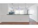 Well-designed kitchen featuring modern white cabinets, stainless steel appliances, and a breakfast bar with pendant lighting at 2288 Street Deville Ne, Atlanta, GA 30345