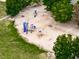 Aerial view showcasing a colorful playground with various play structures and equipment at 329 Lakebridge Xing, Canton, GA 30114