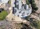 Aerial view showcases a beautifully landscaped home with a spacious backyard, and patio perfect for outdoor living at 329 Lakebridge Xing, Canton, GA 30114