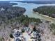 Picturesque aerial view of luxury homes surrounded by lush forests and pristine lake waters at 329 Lakebridge Xing, Canton, GA 30114