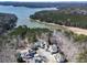 Picturesque aerial view of luxury homes surrounded by lush forests and pristine lake waters at 329 Lakebridge Xing, Canton, GA 30114