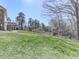 A lush green backyard with mature trees and a wrought-iron fence at 329 Lakebridge Xing, Canton, GA 30114