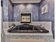 Large soaking tub features a built-in fireplace, creating a cozy and relaxing atmosphere in the bathroom at 329 Lakebridge Xing, Canton, GA 30114