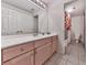 Bathroom features light wood vanity with white countertop and tiled floor at 329 Lakebridge Xing, Canton, GA 30114