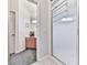 Bright bathroom featuring a shower with a glass door and a small vanity with storage at 329 Lakebridge Xing, Canton, GA 30114