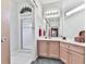 Charming bathroom vanity with pink cabinets, white countertop, and a decorative wreath at 329 Lakebridge Xing, Canton, GA 30114