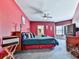 Spacious bedroom features a comfortable bed, TV, ceiling fan, and natural light from the window at 329 Lakebridge Xing, Canton, GA 30114
