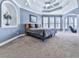 Serene bedroom featuring tray ceilings, ample natural light, and an alcove, creating a peaceful retreat at 329 Lakebridge Xing, Canton, GA 30114