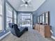Bright bedroom featuring access to an outdoor deck, a vaulted ceiling with fan, and a comfortable chaise lounge at 329 Lakebridge Xing, Canton, GA 30114