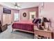 Cozy bedroom with pink walls and carpet, a comfortable bed, and a dresser with a TV at 329 Lakebridge Xing, Canton, GA 30114