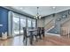 Dining area showcases hardwood floors, sliding glass doors to patio, stairs, and modern light fixture at 329 Lakebridge Xing, Canton, GA 30114